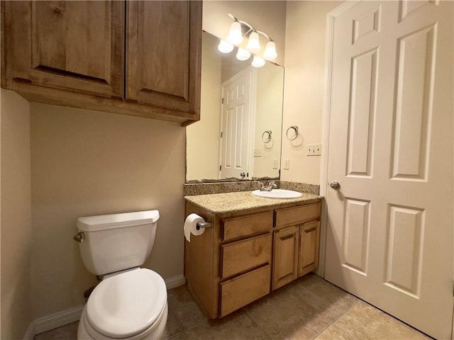 bathroom with tile patterned flooring, vanity, and toilet