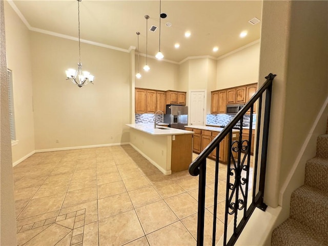 kitchen with hanging light fixtures, stainless steel appliances, tasteful backsplash, a kitchen bar, and light tile patterned flooring