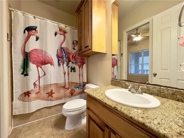 bathroom with ceiling fan, tile patterned flooring, toilet, vanity, and a shower with shower curtain