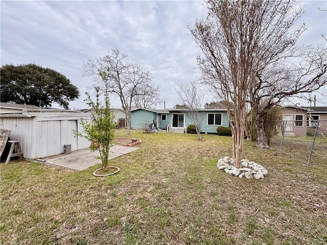 view of yard featuring fence and a patio