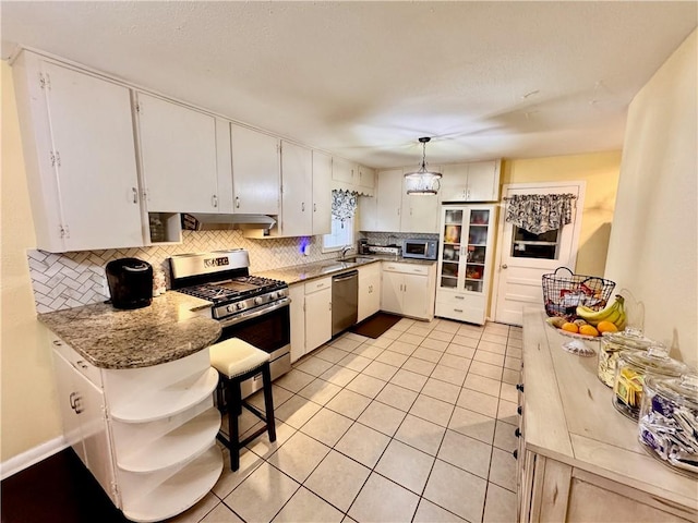 kitchen featuring stainless steel appliances, light tile patterned flooring, white cabinetry, and decorative backsplash