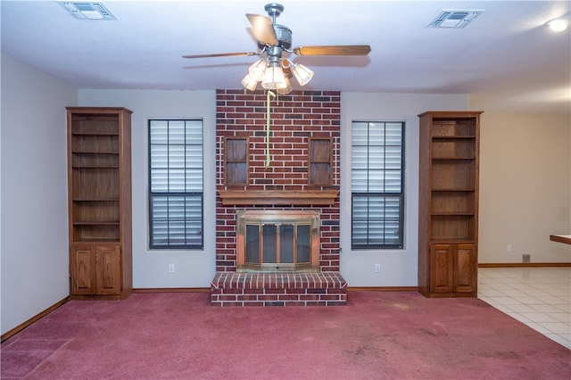 unfurnished living room featuring a fireplace, light colored carpet, a healthy amount of sunlight, and ceiling fan