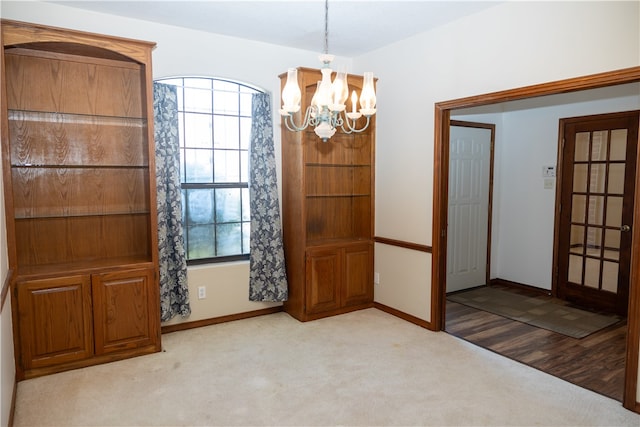 interior space with light carpet and a chandelier