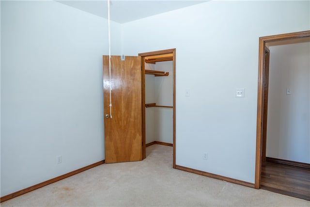 unfurnished bedroom featuring light carpet