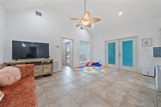 living room with high vaulted ceiling, french doors, light tile patterned floors, and ceiling fan