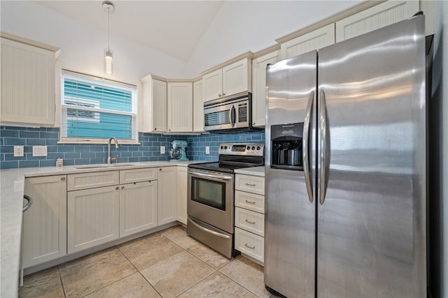 kitchen with stainless steel appliances, sink, decorative light fixtures, lofted ceiling, and decorative backsplash