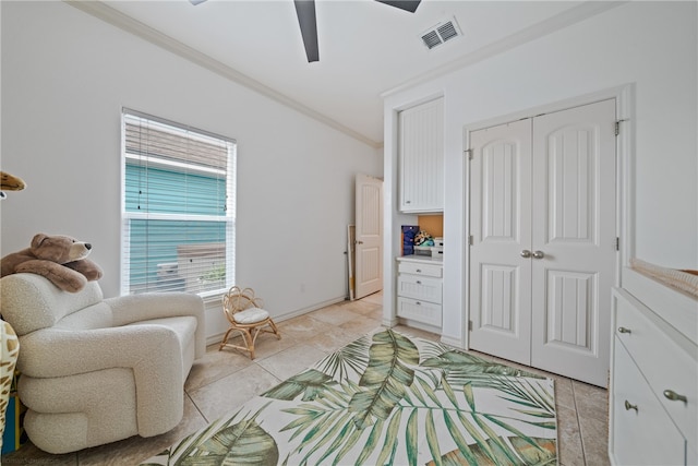 living area with ornamental molding, light tile patterned floors, and ceiling fan