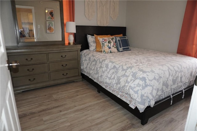 bedroom with wood finished floors