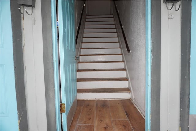 stairway with wood finished floors