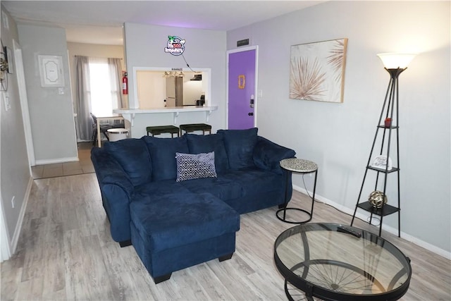 living room featuring light wood-style floors and baseboards