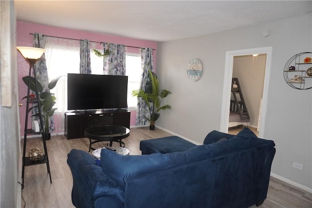 living area with wood finished floors and baseboards