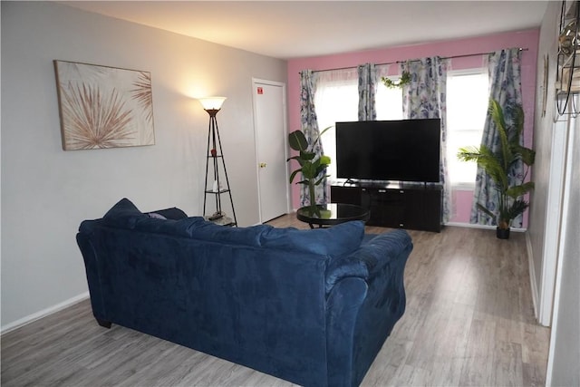 living area with wood finished floors and baseboards