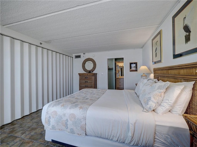 6109 State Highway 361 Unit 601, Port Aransas, TX 78373 - bedroom featuring a textured ceiling