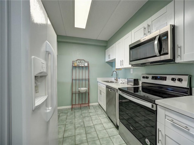 6109 State Highway 361 Unit 601, Port Aransas, TX 78373 - kitchen featuring appliances with stainless steel finishes, white cabinetry, light countertops, and a sink