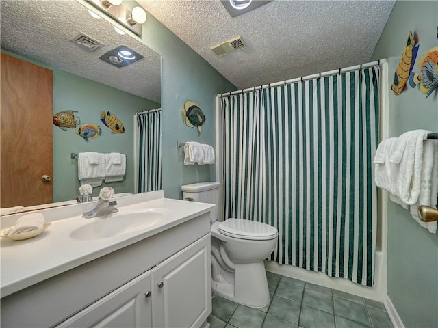 6109 State Highway 361 Unit 601, Port Aransas, TX 78373 - bathroom featuring tile patterned flooring, toilet, vanity, and a textured ceiling