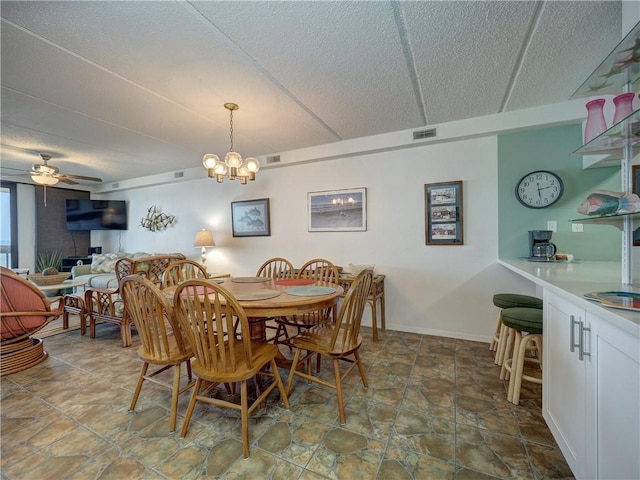 6109 State Highway 361 Unit 601, Port Aransas, TX 78373 - dining area with ceiling fan, a textured ceiling, stone finish floors, and a chandelier