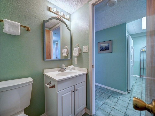 6109 State Highway 361 Unit 601, Port Aransas, TX 78373 - bathroom featuring vanity, tile patterned floors, toilet, and a textured ceiling
