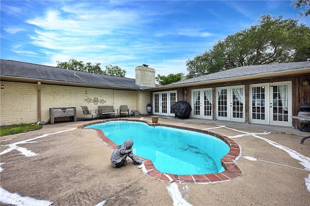 view of pool featuring a patio area and french doors