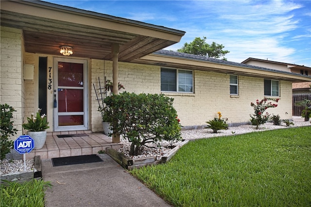 entrance to property with a yard