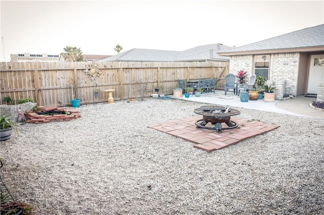 view of yard featuring a fire pit and a patio