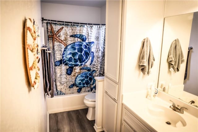 full bathroom with vanity, toilet, hardwood / wood-style floors, and shower / bathtub combination with curtain