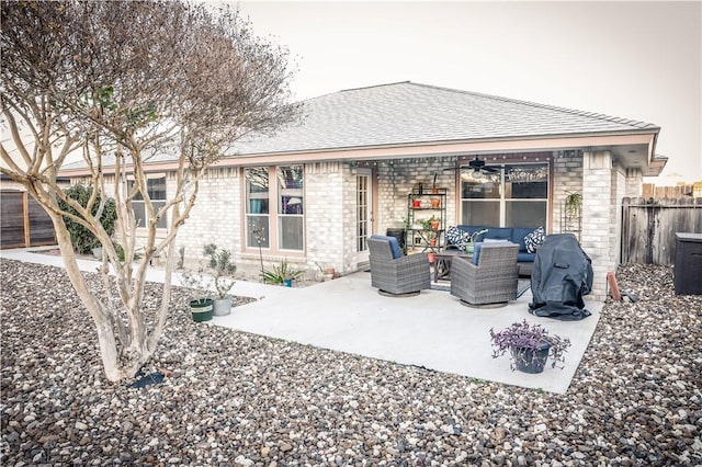 rear view of property with an outdoor living space, a patio area, and ceiling fan