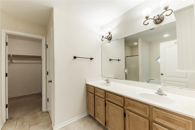 bathroom with tile patterned flooring, vanity, and a shower with shower door