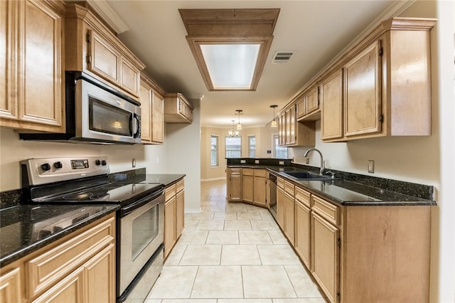 kitchen with stainless steel appliances, sink, pendant lighting, a chandelier, and light tile patterned flooring