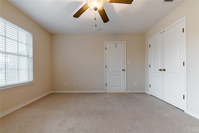 unfurnished bedroom with light carpet and ceiling fan