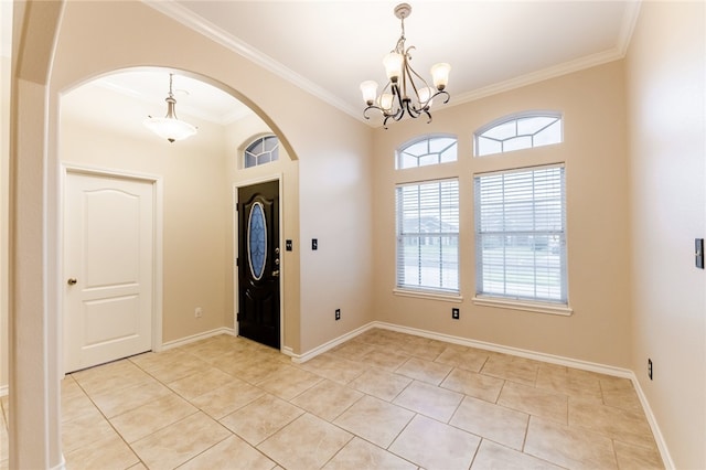 entrance foyer featuring light tile patterned floors, crown molding, and a chandelier