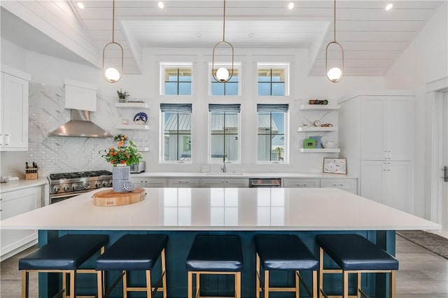 kitchen featuring open shelves, wooden ceiling, decorative backsplash, a breakfast bar, and white cabinets