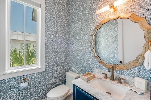 half bathroom featuring toilet, backsplash, and vanity