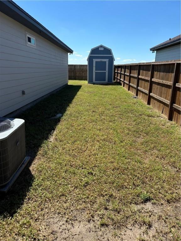 view of yard featuring central AC and a storage shed