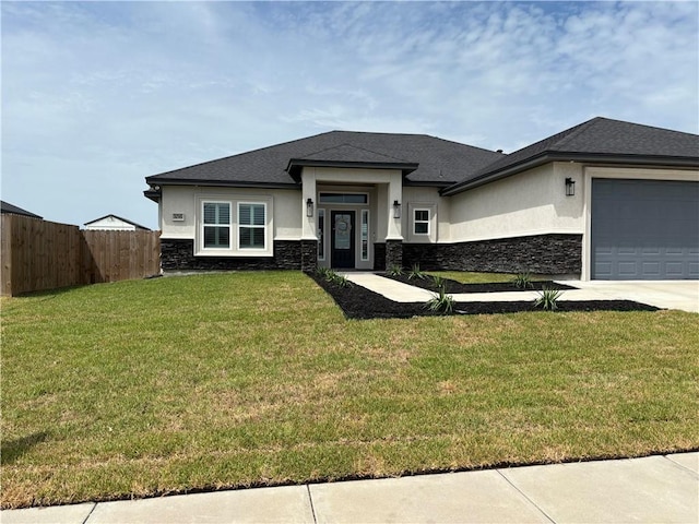 106 Webb St, Odem, TX 78370 - prairie-style house featuring stone siding, stucco siding, an attached garage, and driveway