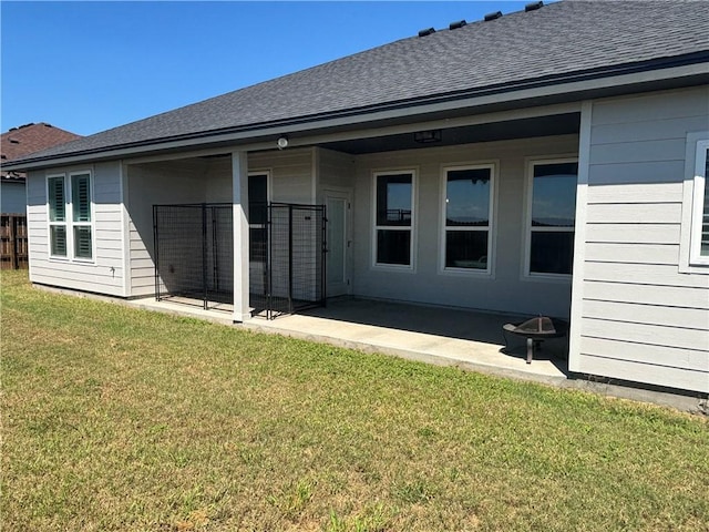 rear view of property with a yard and a patio area