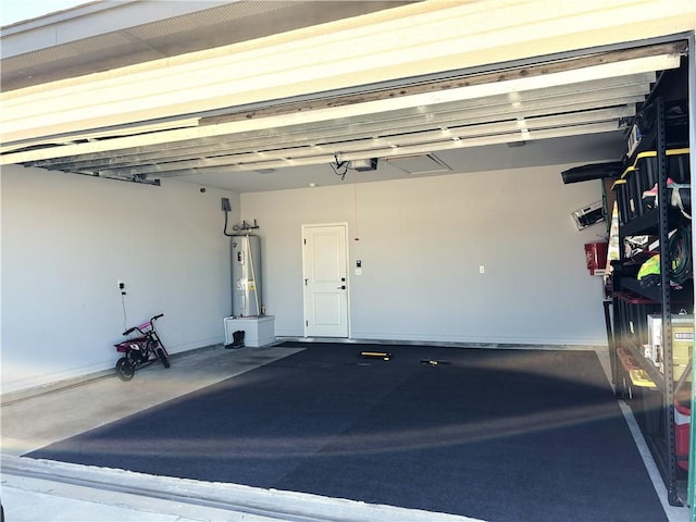 garage with a garage door opener and electric water heater