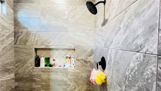 interior details featuring a tile shower