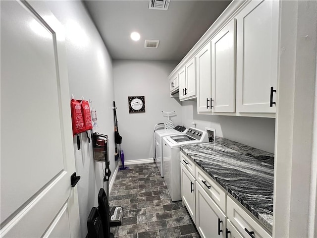 laundry room featuring cabinets and separate washer and dryer