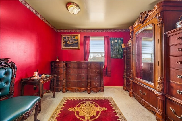 sitting room featuring light colored carpet