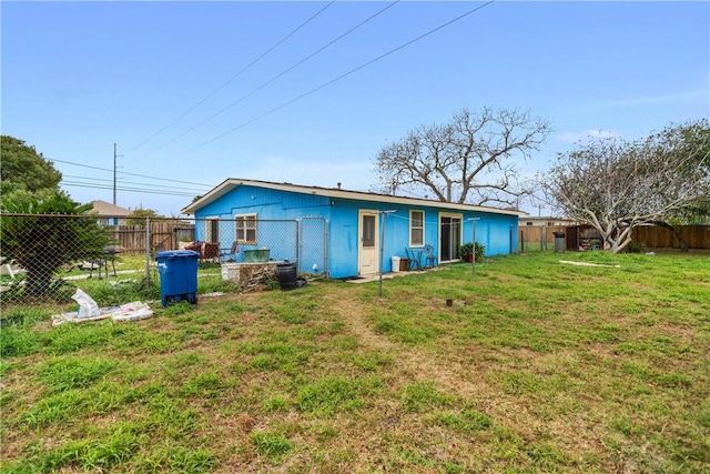 rear view of house with a yard