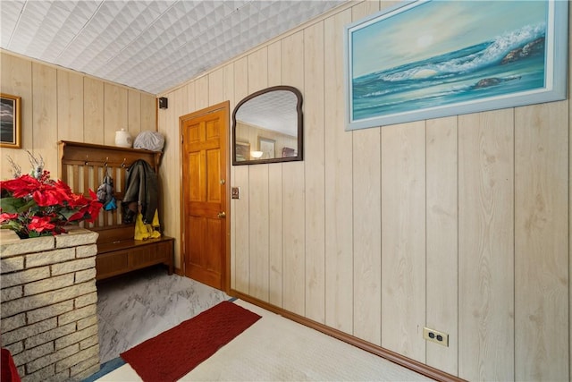 foyer featuring wooden walls