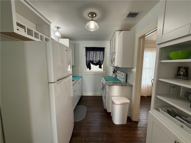 kitchen with white cabinets, dark hardwood / wood-style flooring, and white appliances