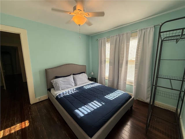 bedroom with ceiling fan and dark hardwood / wood-style flooring