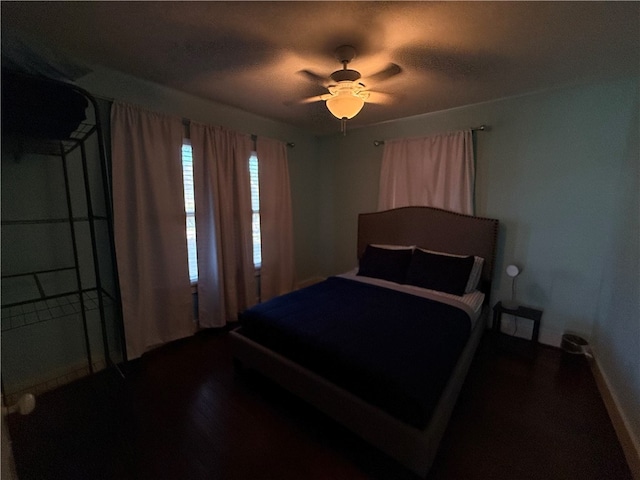 bedroom with ceiling fan and dark hardwood / wood-style floors