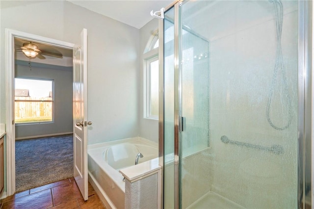 bathroom with ceiling fan and separate shower and tub