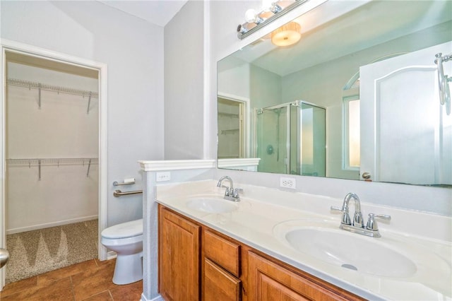 bathroom featuring vanity, toilet, and walk in shower