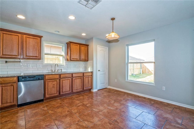 kitchen featuring pendant lighting, sink, dishwasher, light stone countertops, and decorative backsplash