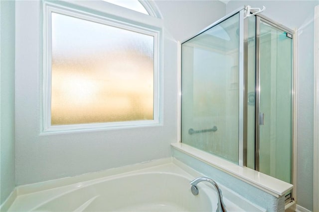 bathroom featuring shower with separate bathtub