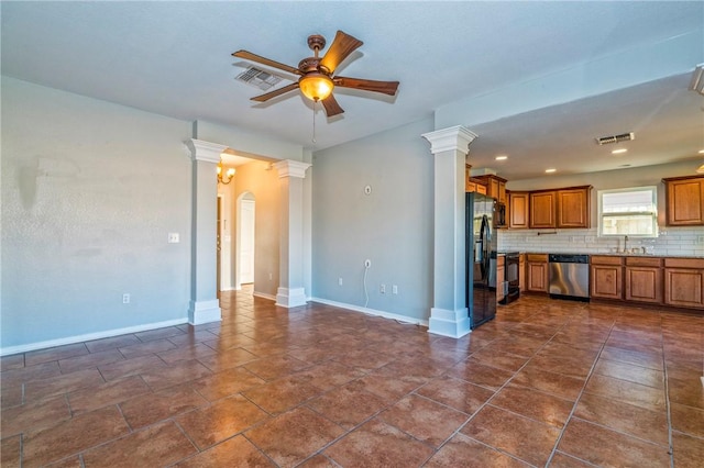 unfurnished living room featuring sink, ceiling fan, and ornate columns