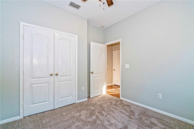 unfurnished bedroom with a closet and carpet